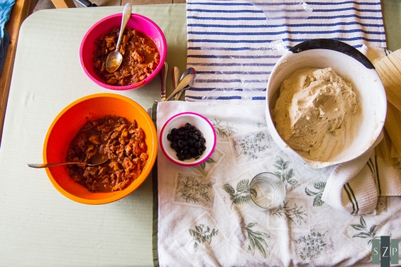 Meat (pork & beef), sauce, olives and masa.